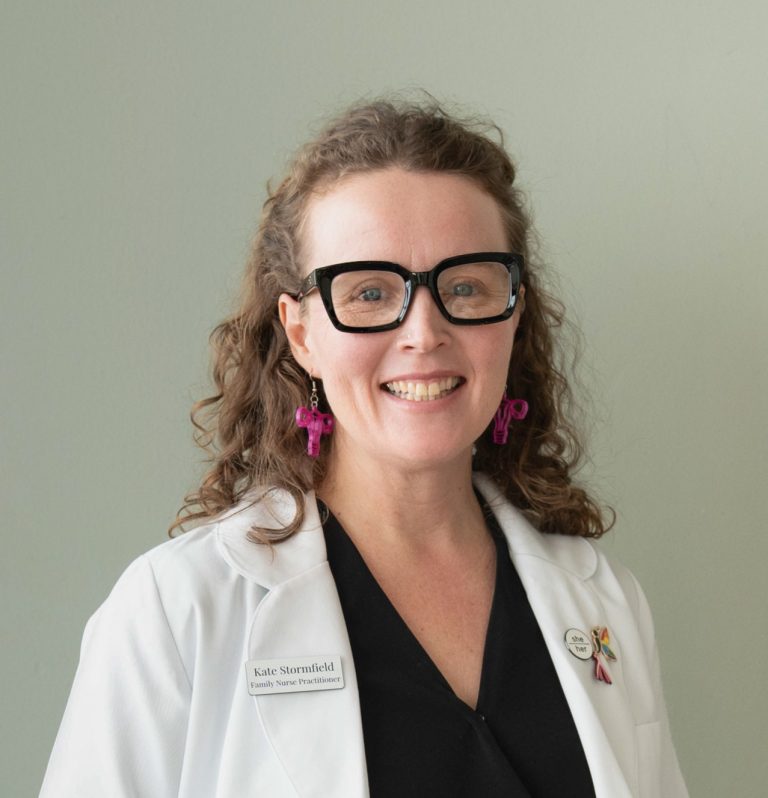 Kate Stormfield wearing a white coat